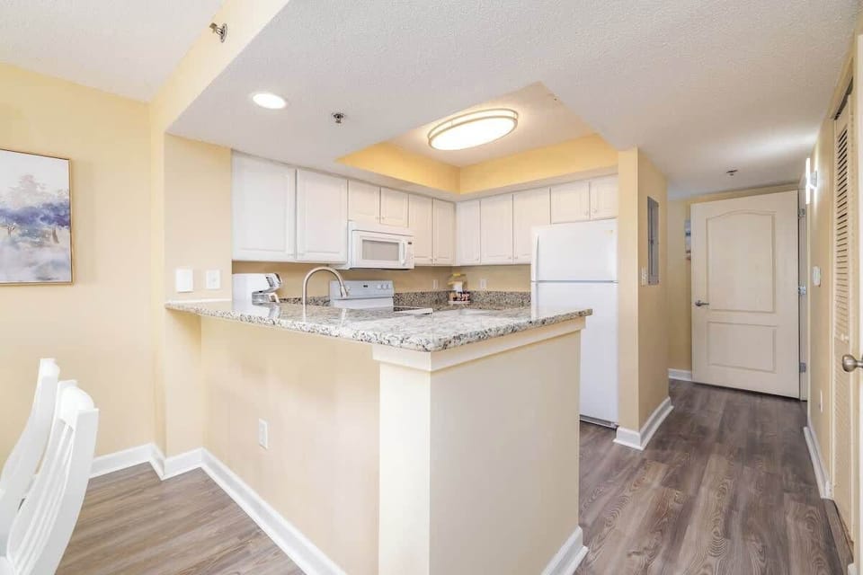 Spacious, well-equipped kitchen w/ granite countertops, flat-top range, fridge/freezer, dishwasher, microwave, drip/Keurig coffee maker, popcorn station, blender,pots,pans, baking sheets, mixing bowls, cutting boards, dishes, serving utensils & more!