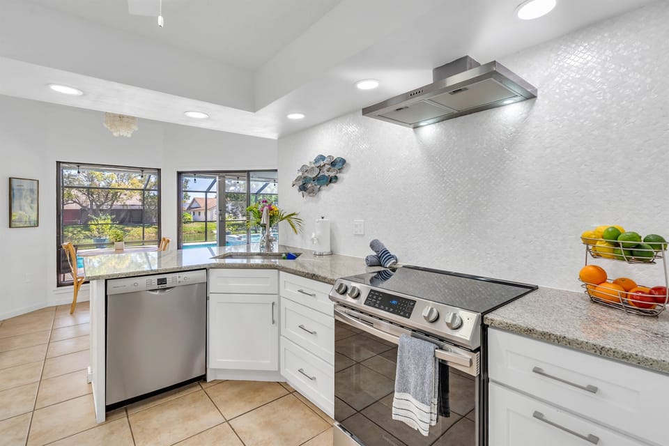 The newly updated kitchen includes full-sized appliances, granite countertops and tile backsplash.