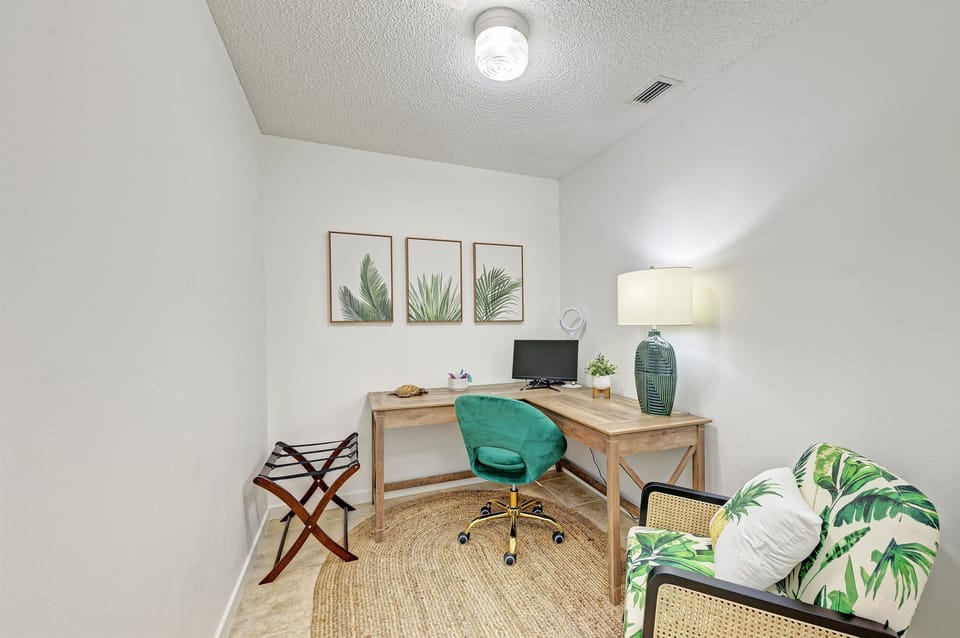 The office is located in the primary bedroom and has french doors so you can check in with work as needed.