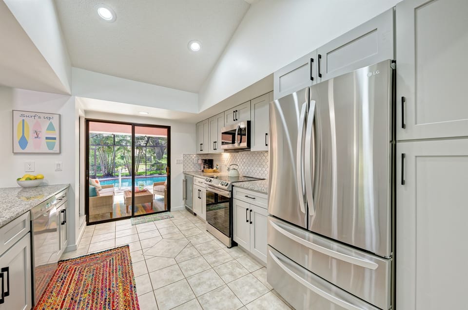 The kitchen at Palma Rosa includes stainless appliances, granite countertops, and everything needed to cook and bake.