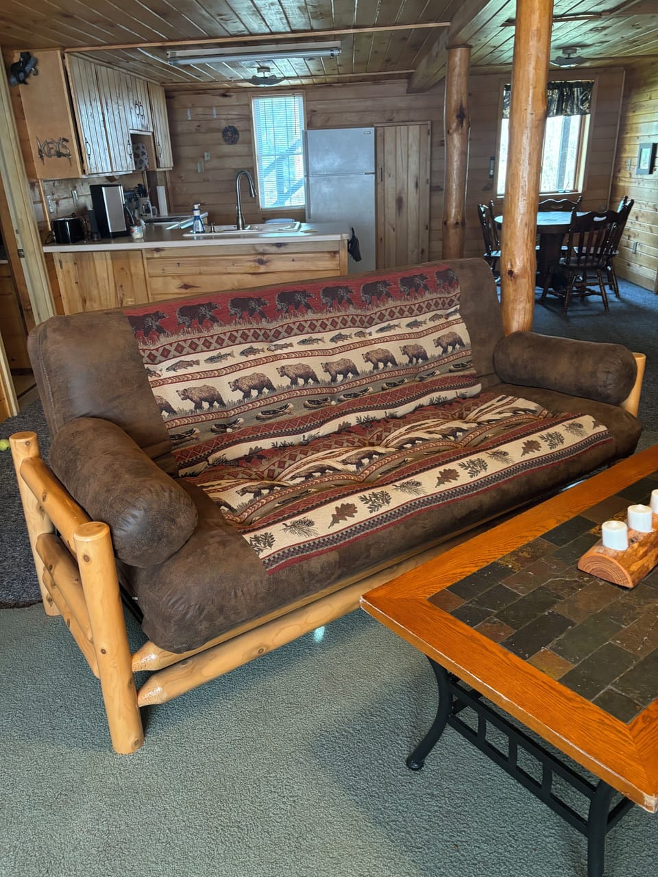 Futon couch main level - lays flat for sleeping position.
