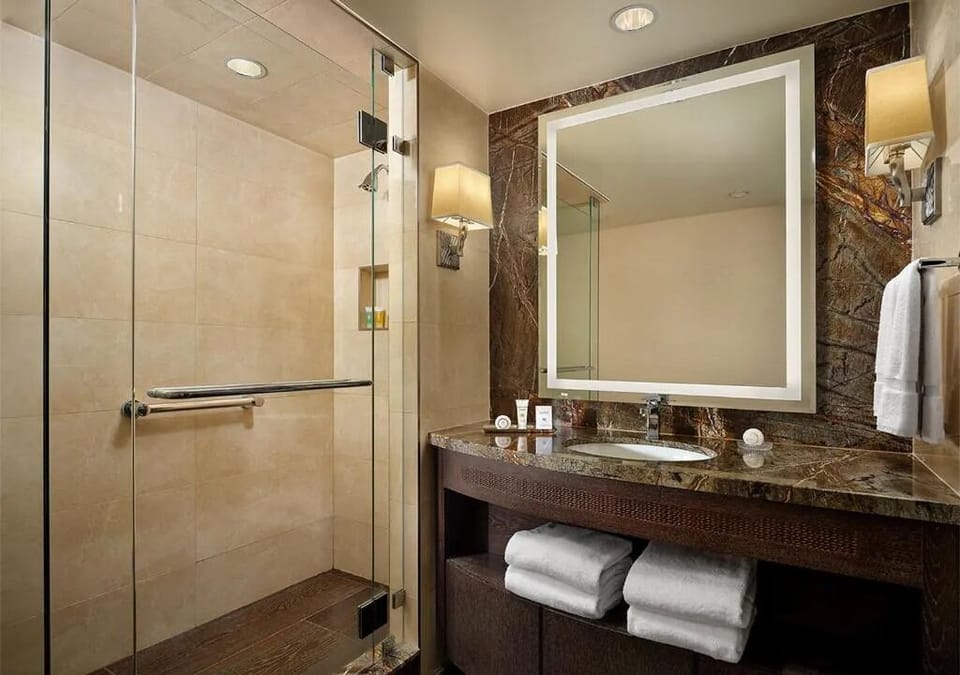 Step into a spacious glass shower for an easy reset.