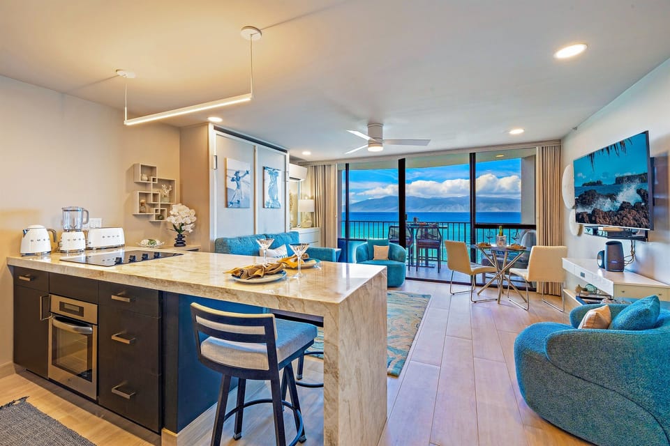Living Room: Unwind in style with stunning ocean views and vibrant decor for your Hawaiian escape.