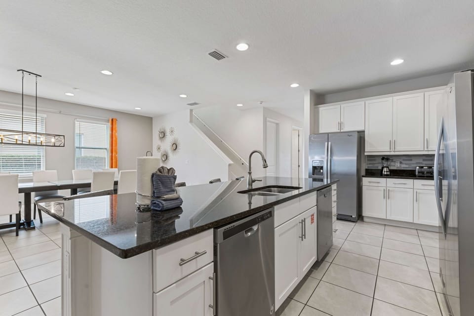 Modern kitchen with island and dining area, perfect for entertaining.