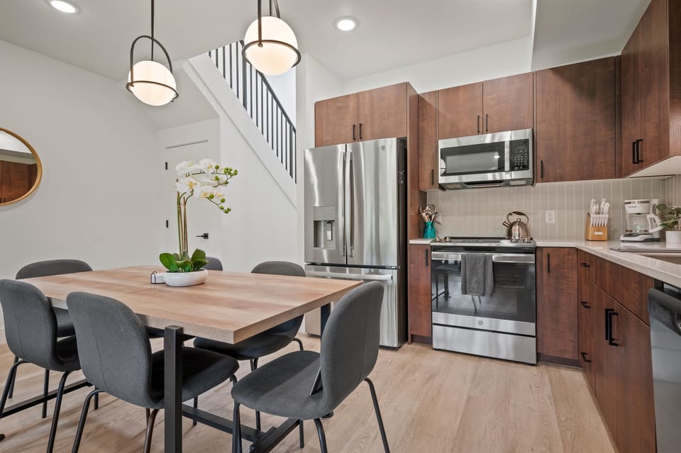 The gourmet kitchen is equipped with appliances, including a microwave, stove, and spacious refrigerator.