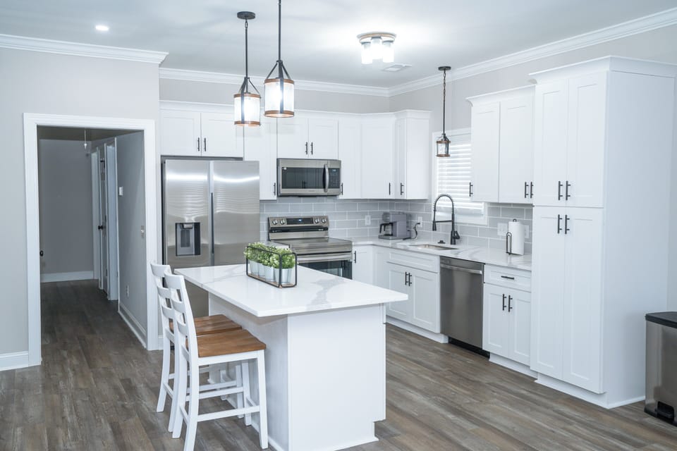 Bright, modern kitchen with island seating and stainless appliances