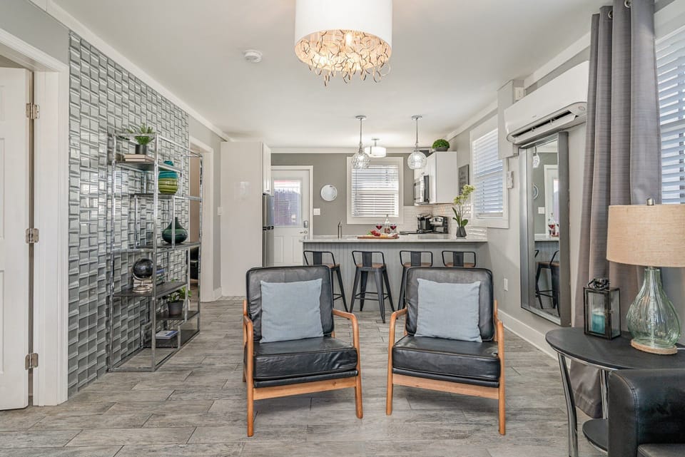 Relax in style with cozy seating, modern decor, and a seamless flow to the kitchen—perfect for comfort and connection!