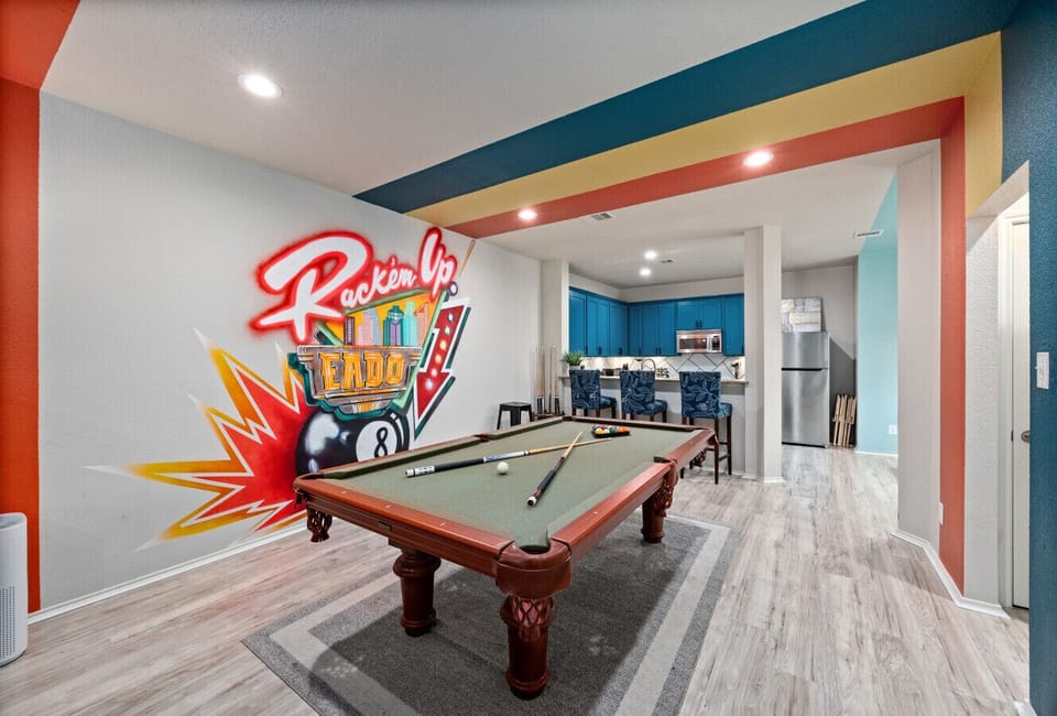 Game nights made easy—pool table positioned in the heart of the home with direct sightlines to the kitchen and dining area.