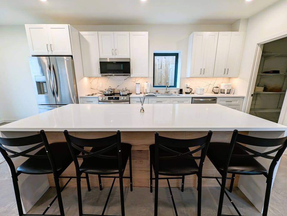 Fully-equipped contemporary chef's kitchen with high end appliances.