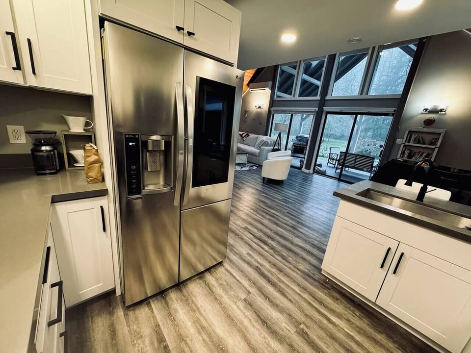 The large fully stocked kitchen flows into the open living and dining area. In the kitchen make use of the coffee station with several types of coffee makers and a cabinet full of local coffee choices. And... there's an ice cream maker
