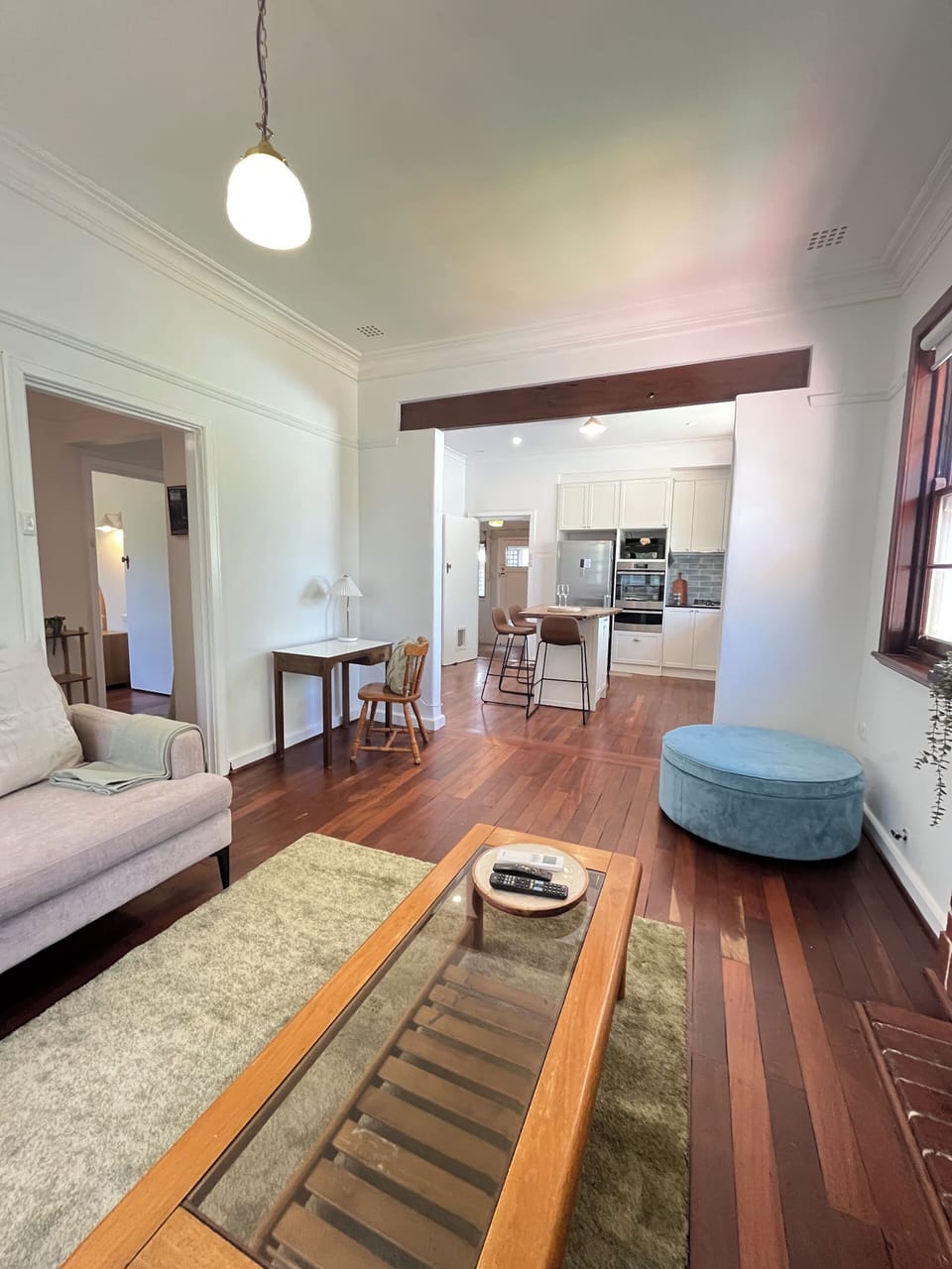 Designed for both relaxation and productivity, this versatile open-plan space offers comfortable lounging, a full kitchen, and a quiet desk area for catching up on tasks.