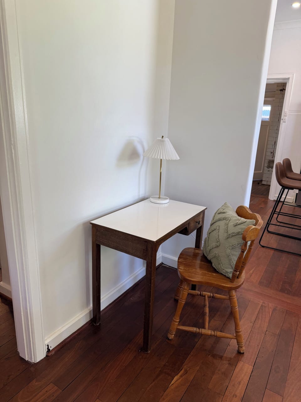 We've included a designated spot for your laptop or journaling. This charming table with its comfortable chair and inviting lamp is ready for your needs.