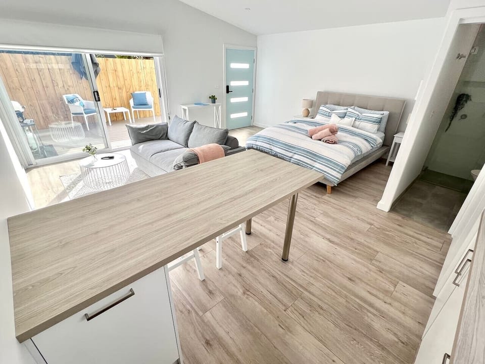 Bright studio with private patio, cozy seating, and indoor-outdoor charm