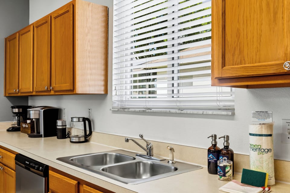 Fully equipped open-concept kitchen with modern appliances and bar seating.