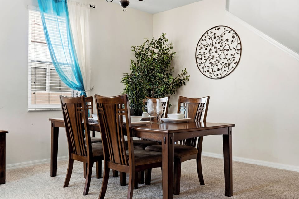 Spacious additional living area with comfortable seating and a dining table.
