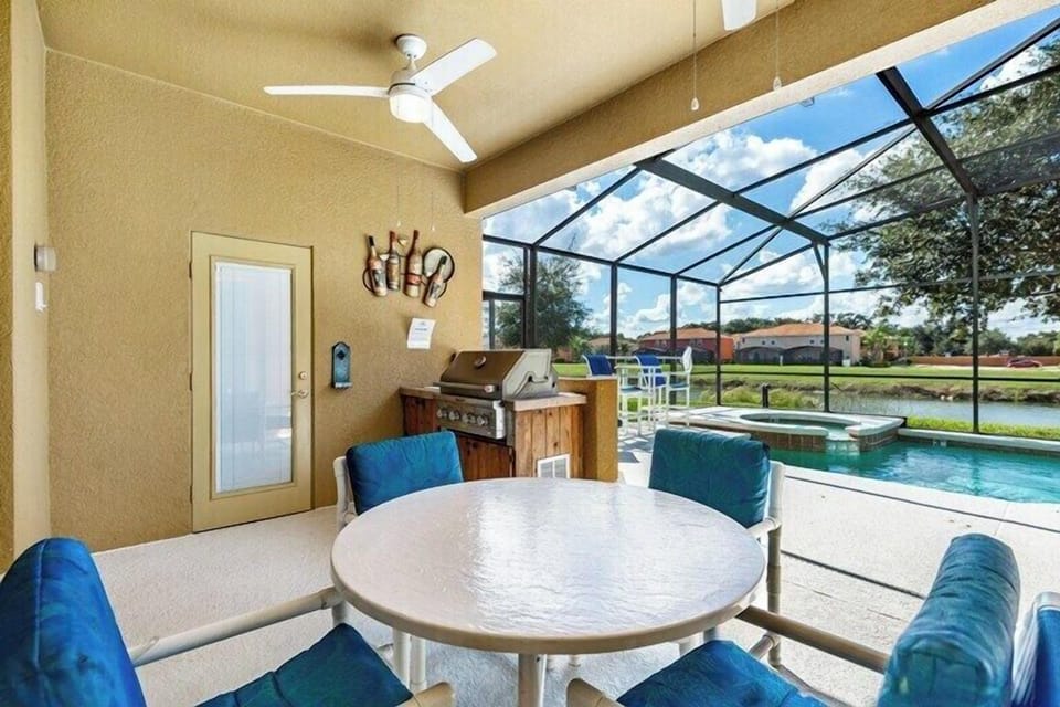 Covered dining with built in BBQ - Beautiful pool deck views!