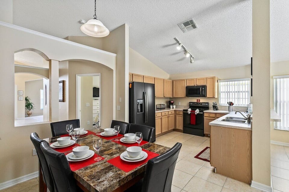 The open-concept kitchen with breakfast bar seating for four is a modern and sophisticated centerpiece of the home, blending functionality with style.
