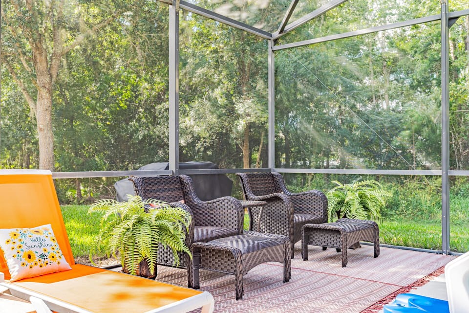 Enjoy your own private screened pool with peaceful nature views, comfortable outdoor seating, and sunny loungers