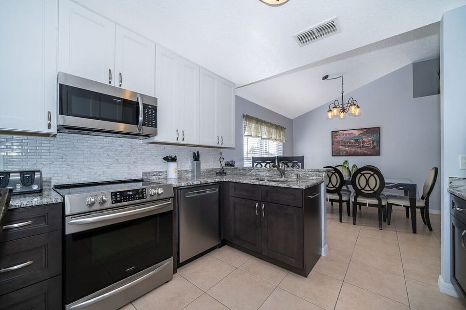 Step into the updated large kitchen that seamlessly connects to an inviting open dining area, creating the perfect environment for family meals.