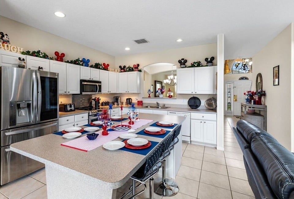 Large updated kitchen with stainless steel appliances and breakfast bar seating for 6