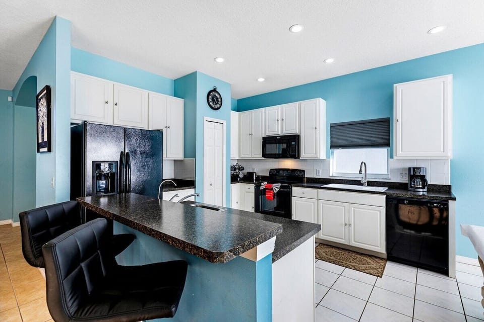 The spacious kitchen is a chef's dream, featuring modern appliances, ample counter space, and custom cabinetry.