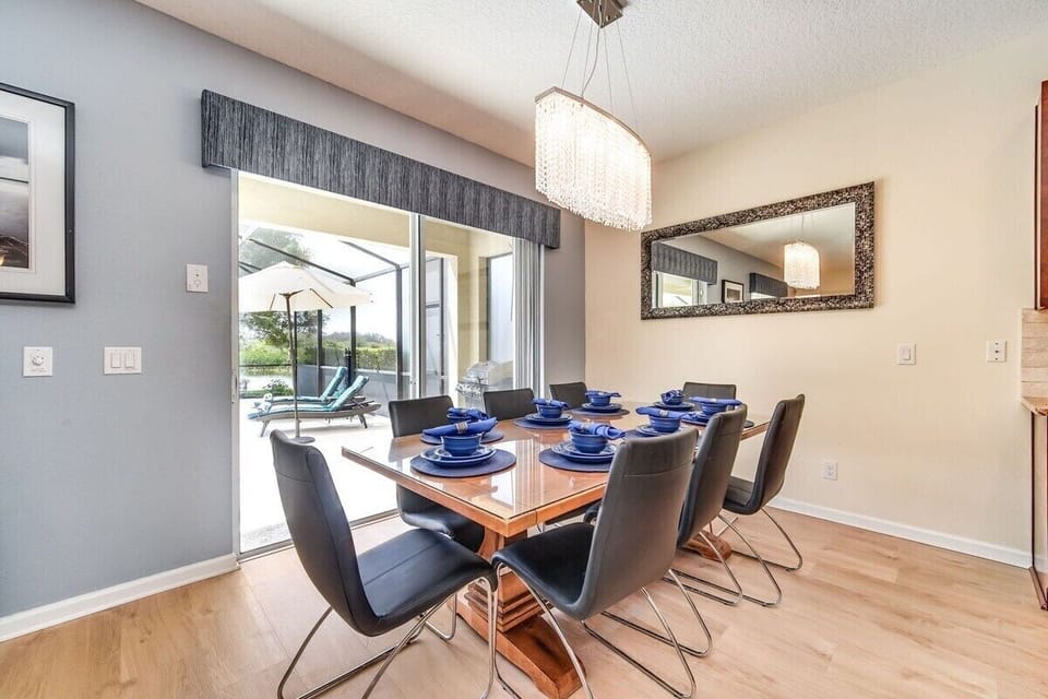 Dining room with seating for 8 and a stunning pool view with direct access to the deck.