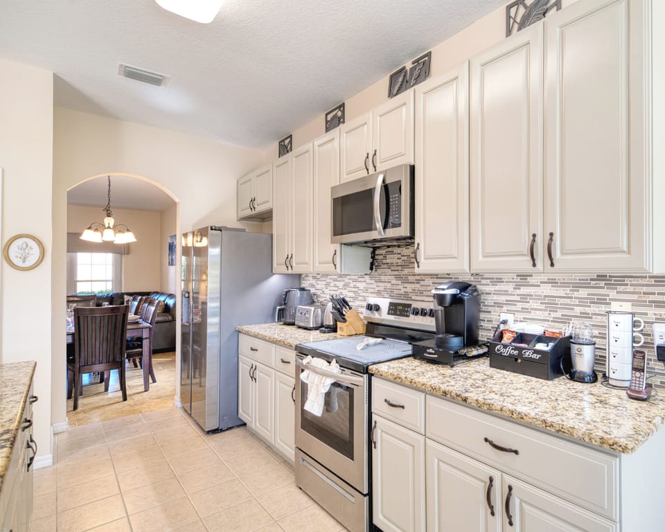 Spacious kitchen with stainless steel appliances, granite countertops, and all the cookware and utensils you need for family meals.
