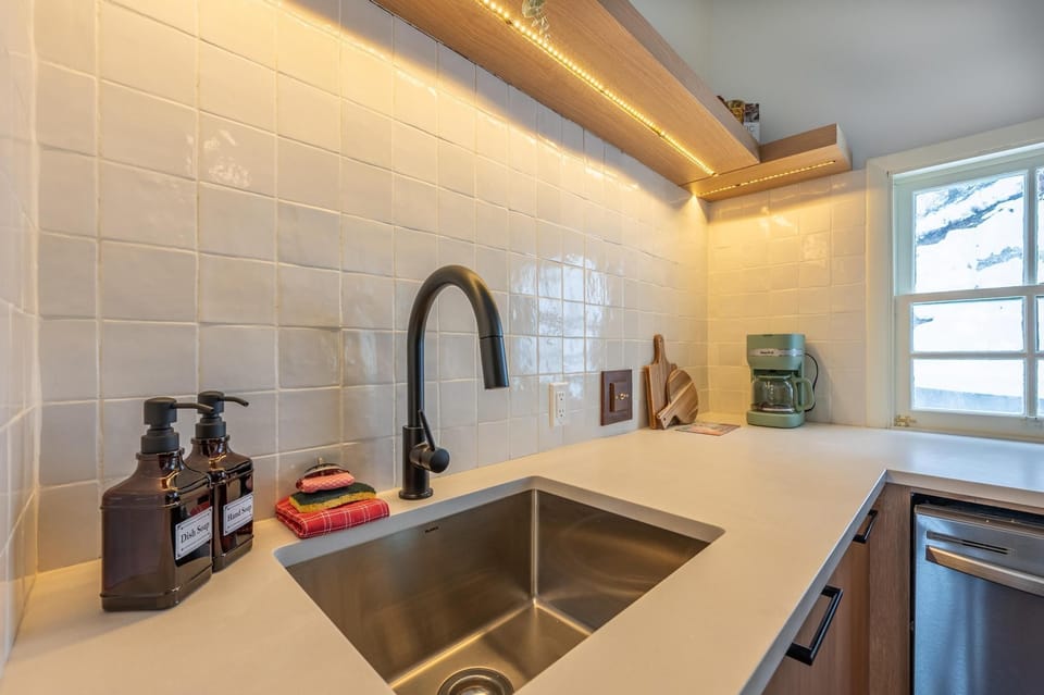 Well-stocked sink station with modern fixtures, a coffee maker, and everything for cozy mountain meals.