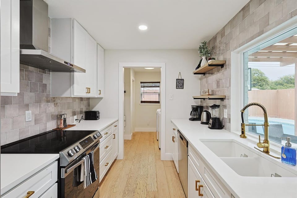This stunning fully equipped kitchen is perfectly designed to delight any home chef! Sparkling white with upgraded features and luxurious gold hardware, this dream kitchen looks like it waltzed off the latest HGTV show.