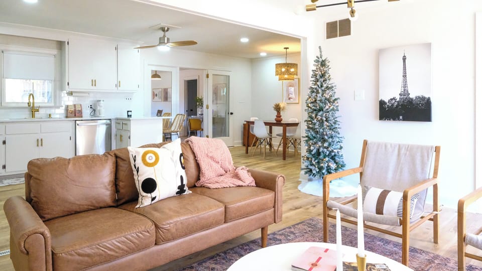 Cozy couch in front living room with open concept to full kitchen.