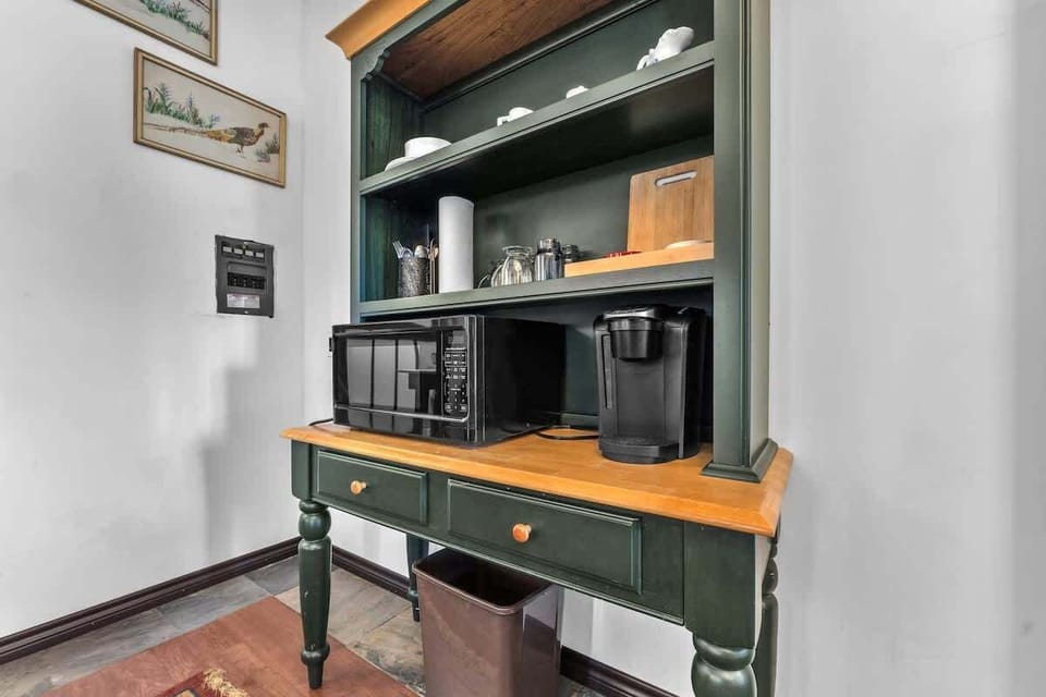 The coffee bar is equipped with a keurig, microwave and mini fridge.