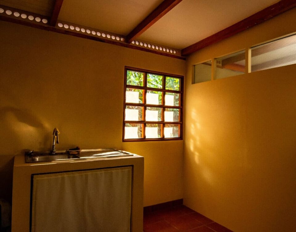 Utility sink area with natural light and simple design in Playa Chiquita, Casa Rakú