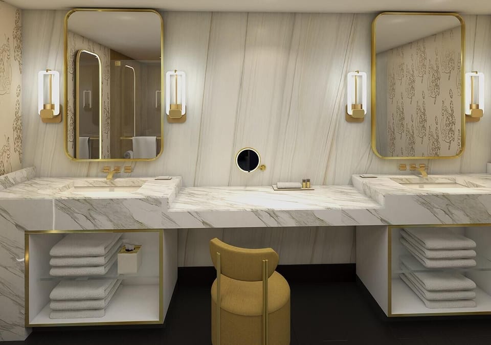 Refresh at the double vanity with marble and warm lighting.