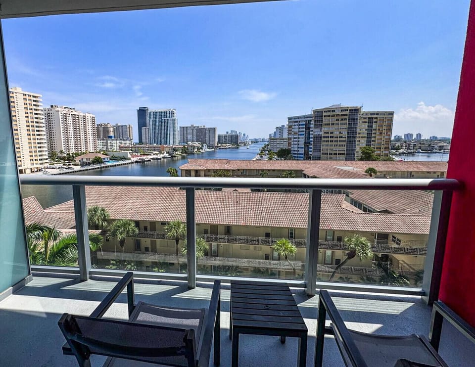 Private balcony with outdoor seating and skyline views.