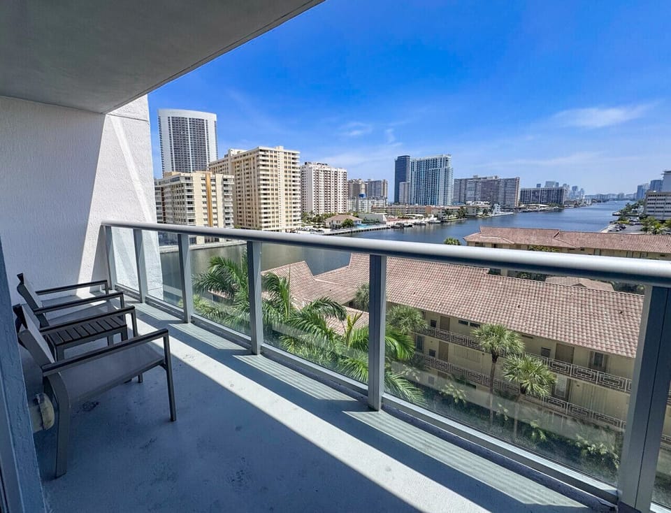 Private balcony with outdoor seating and skyline views.
