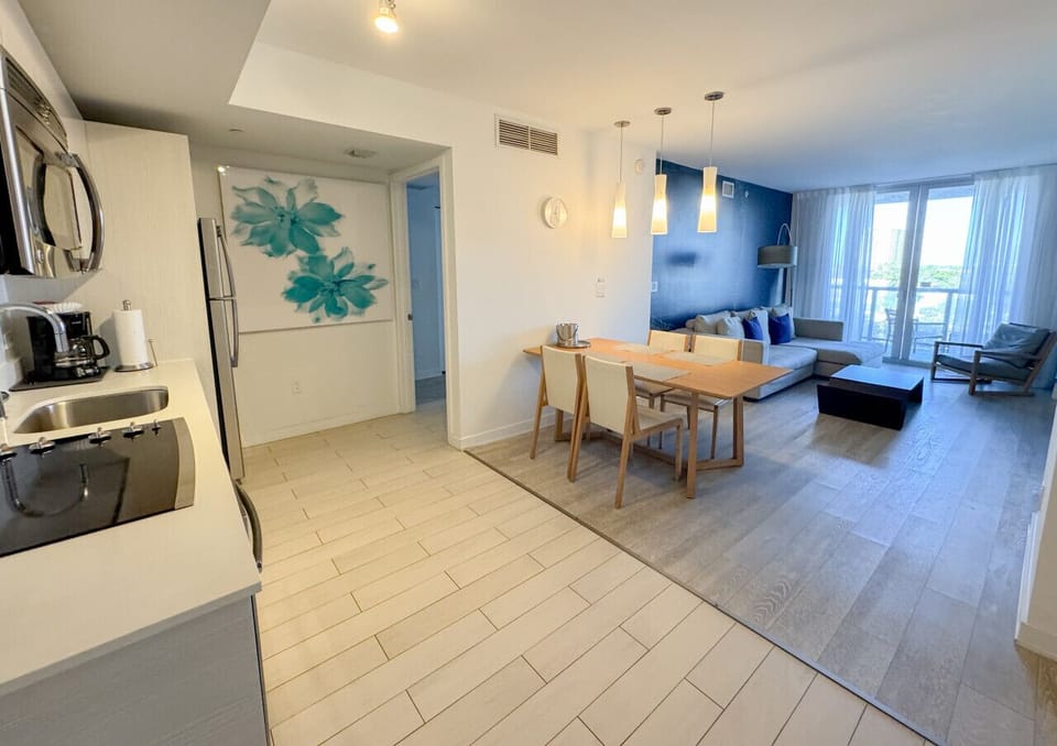 Modern dining area connected to a fully equipped kitchen.