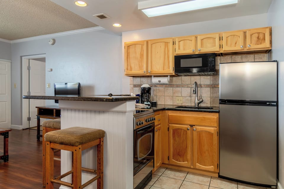 Cook simple meals with fridge, microwave, and convenient counter space.
