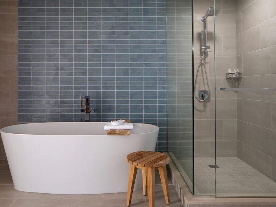Soak and reset in a sleek tub-and-rain-shower retreat.