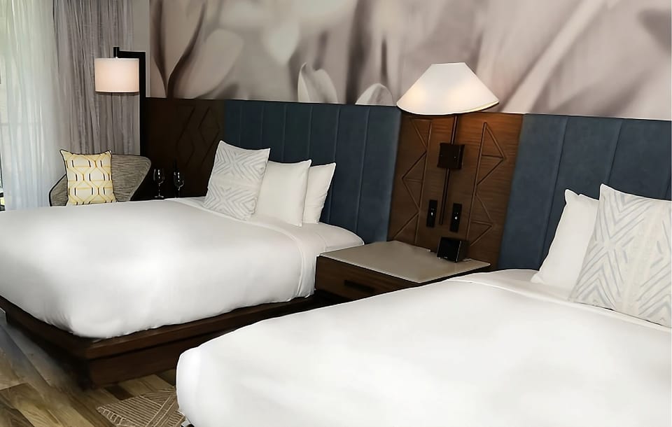 Relax under soft lighting and a stylish upholstered headboard.