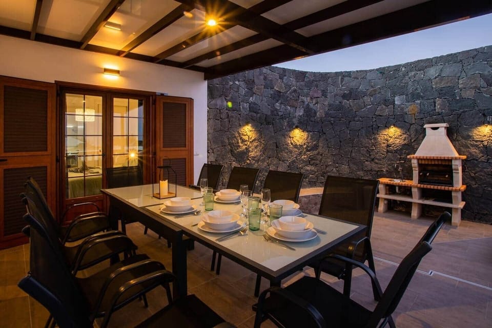 Shaded dining area at Villa Amana by the grill – space for the whole group.
