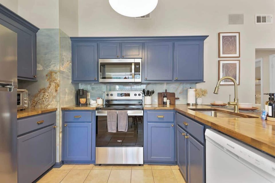 The striking blue cabinetry brings life and charm to this kitchen, creating a fun spot to prepare meals. 