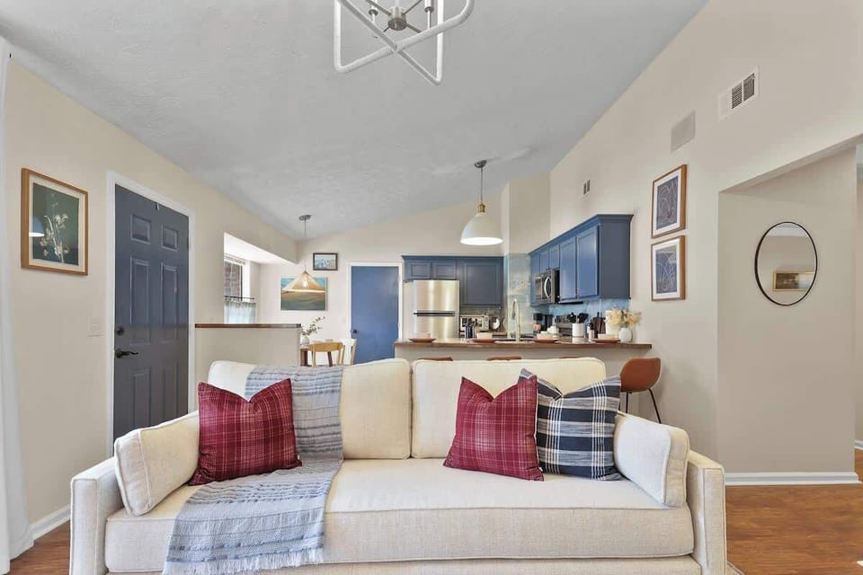 A living room that overlooks the blue kitchen, creating a seamless space that is perfect for cooking, chatting and entertaining. 
