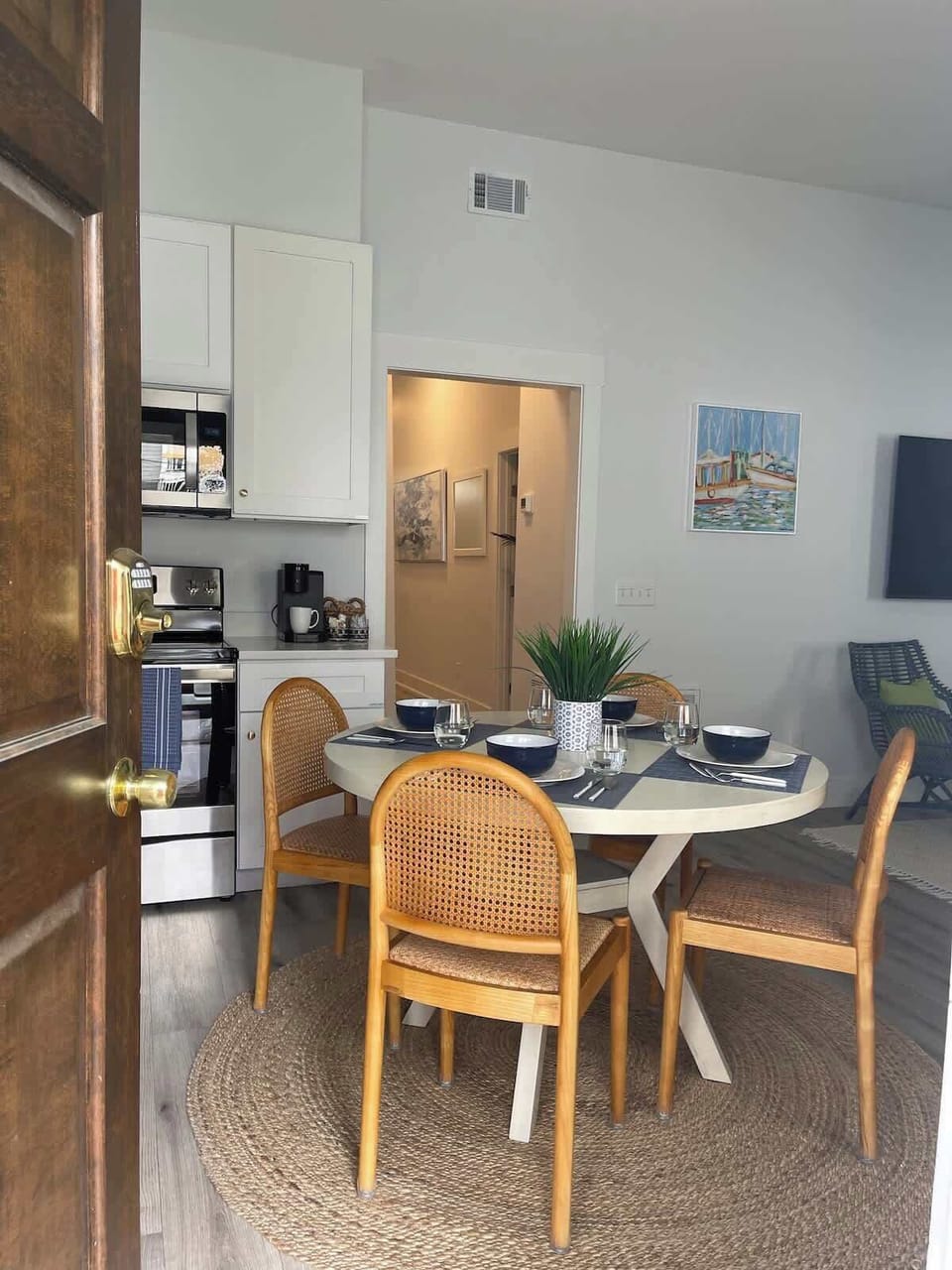 Compact dining space designed for style and functionality within an open-concept layout. The kitchen also leads out into the backyard. 