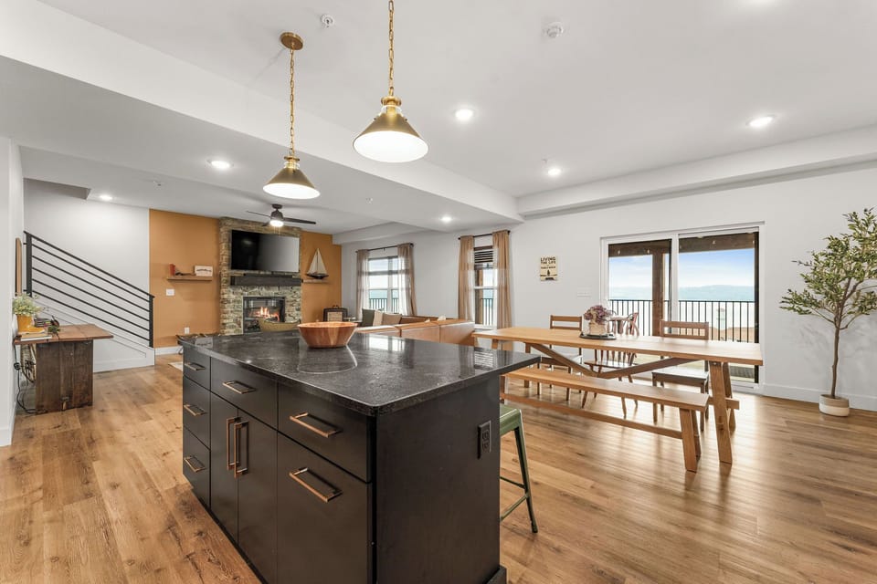 - Cook up in this stunning open concept kitchen and dining space
- Bold island and farmhouse table invite unforgettable meals and lively conversations
- Bathed in golden light, modern lines meet rustic charm in a scene of effortless elegance