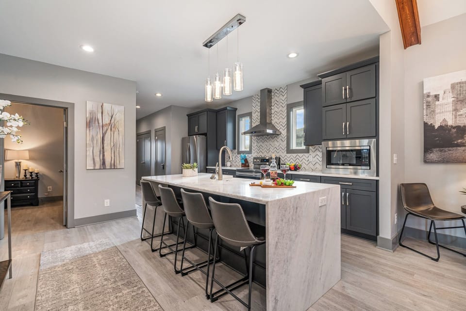 Modern kitchen with sleek countertops, stainless steel appliances, and a spacious island—ready for meals and memories!