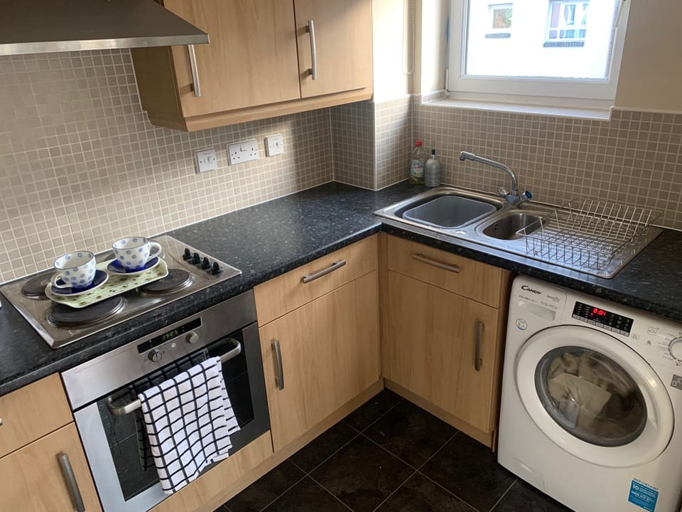 Fully equipped kitchen plenty of cupboard space integrated refuse bin