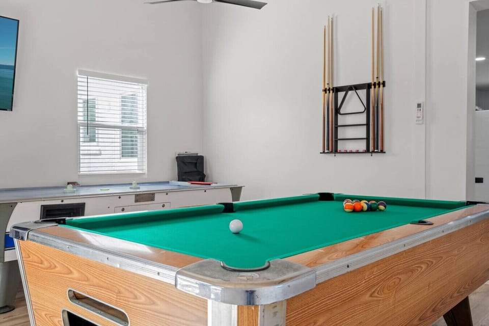 The spacious, open game room, flooded with natural light and offering easy outdoor access, is the ideal place for fun, relaxation, and making lasting memories.