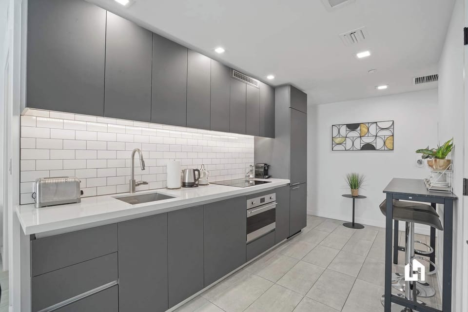 Modern kitchen & living area. Enjoy city views!