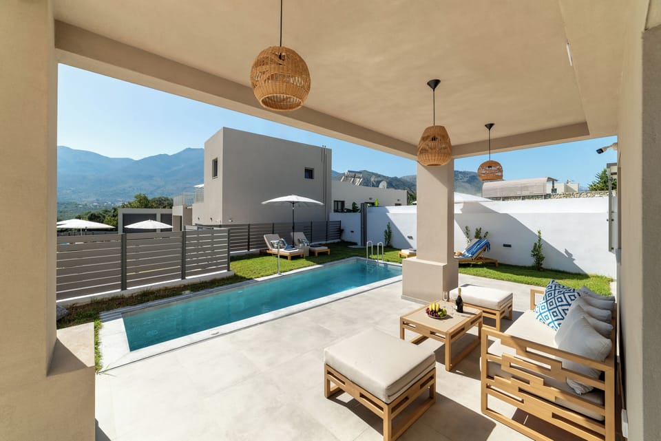 KS Omega Villa - outdoor space with swimming pool, sun beds and seating area
