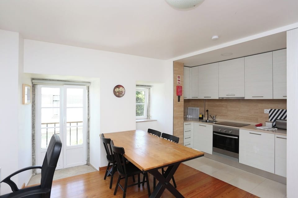 Living room and kitchen. Table that sits four.